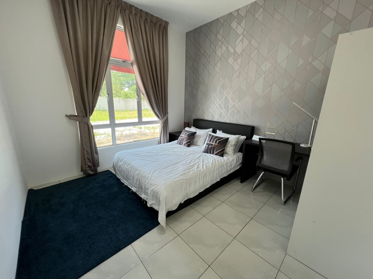 Bedroom with fitted wardrobe and desk in the 1-bedroom show unit