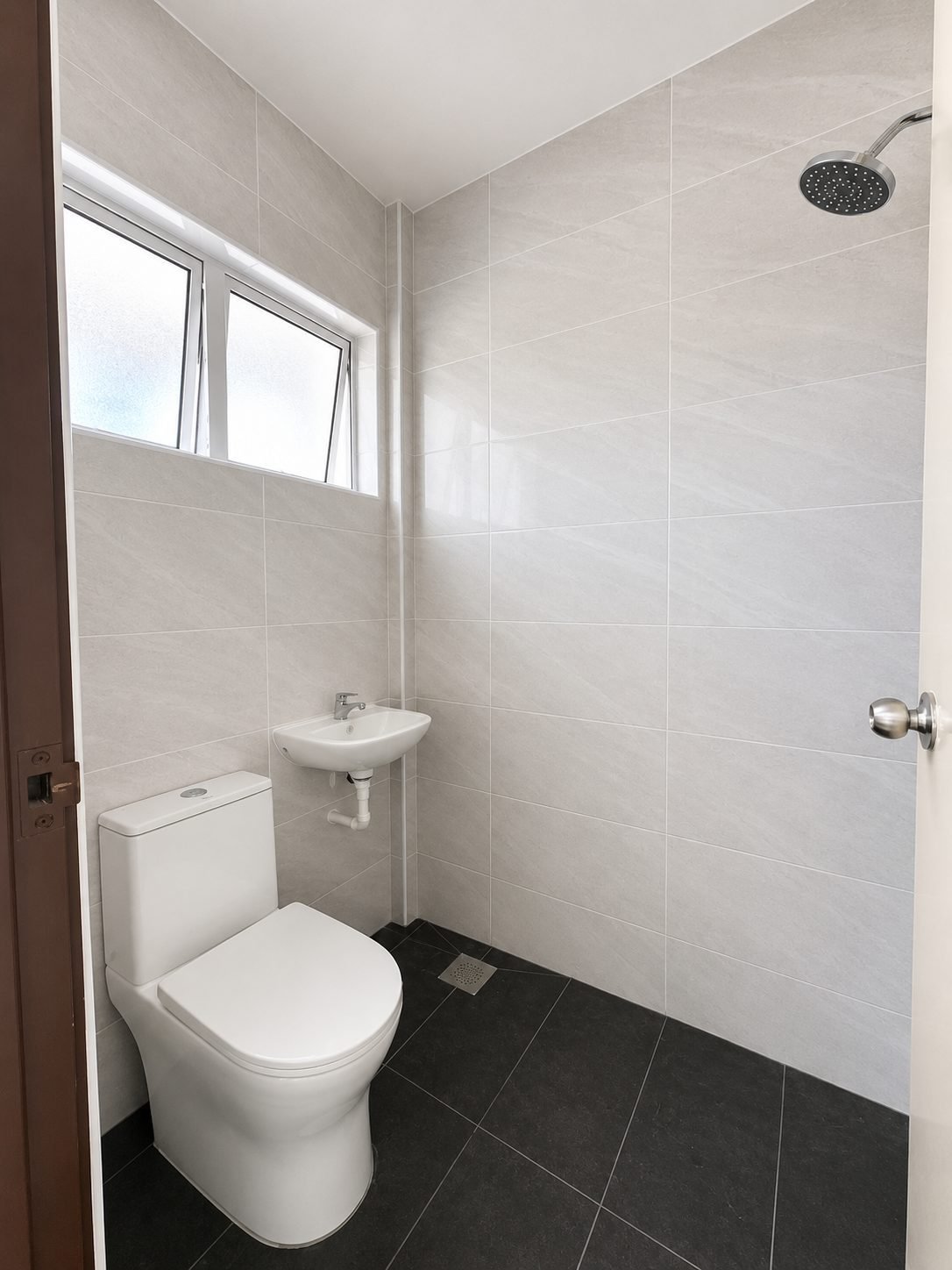 Bathroom with a shower area and dark floor tiling, Arena Perpaduan Utama