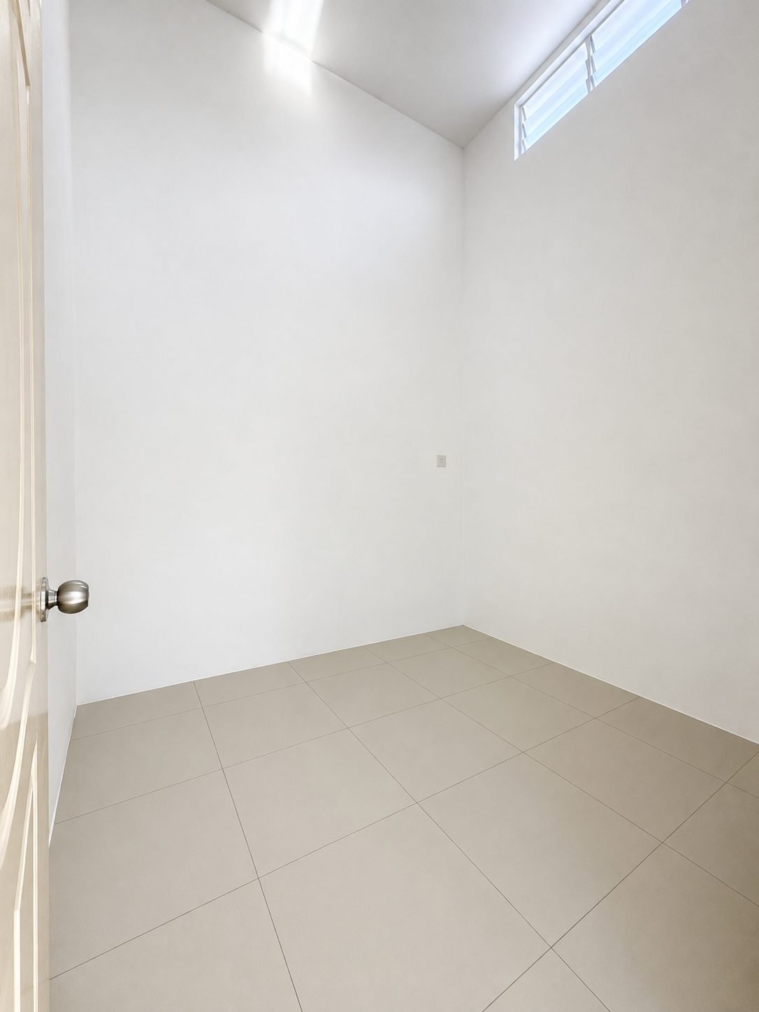 Bedroom lit by a high clerestory window, Arena Perpaduan Utama