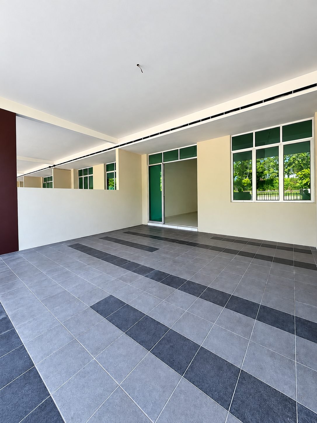 An unfurnished unit at Taman Gopeng Mewah as handed over, looking from the living area to the rear