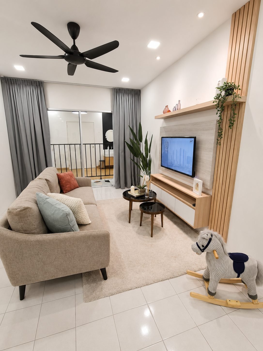 Living room with feature TV wall in the Type B show unit at Residensi Jati De Meru, Ipoh