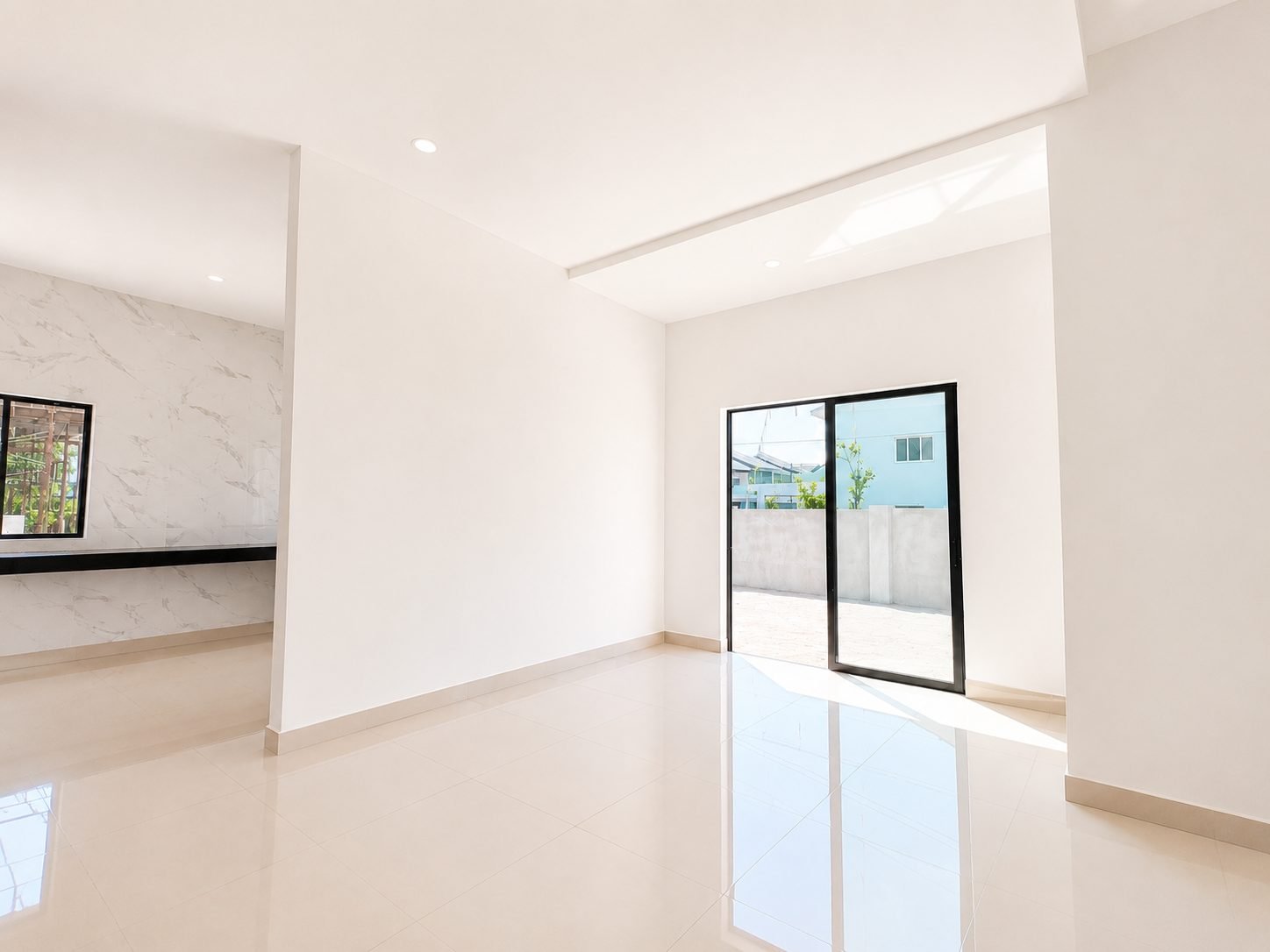 Dining area with a marble-look feature wall at the Taman Lapangan Indah show house