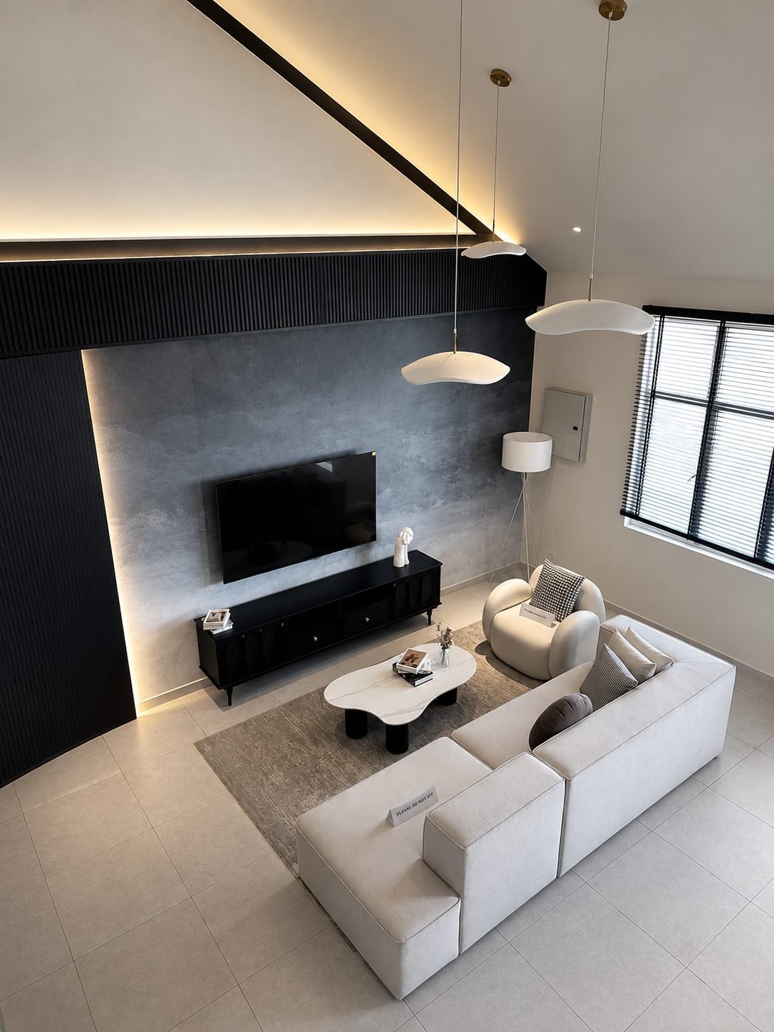 Living room with a dark feature wall and pendant lighting under a high ceiling, Pearl Garden