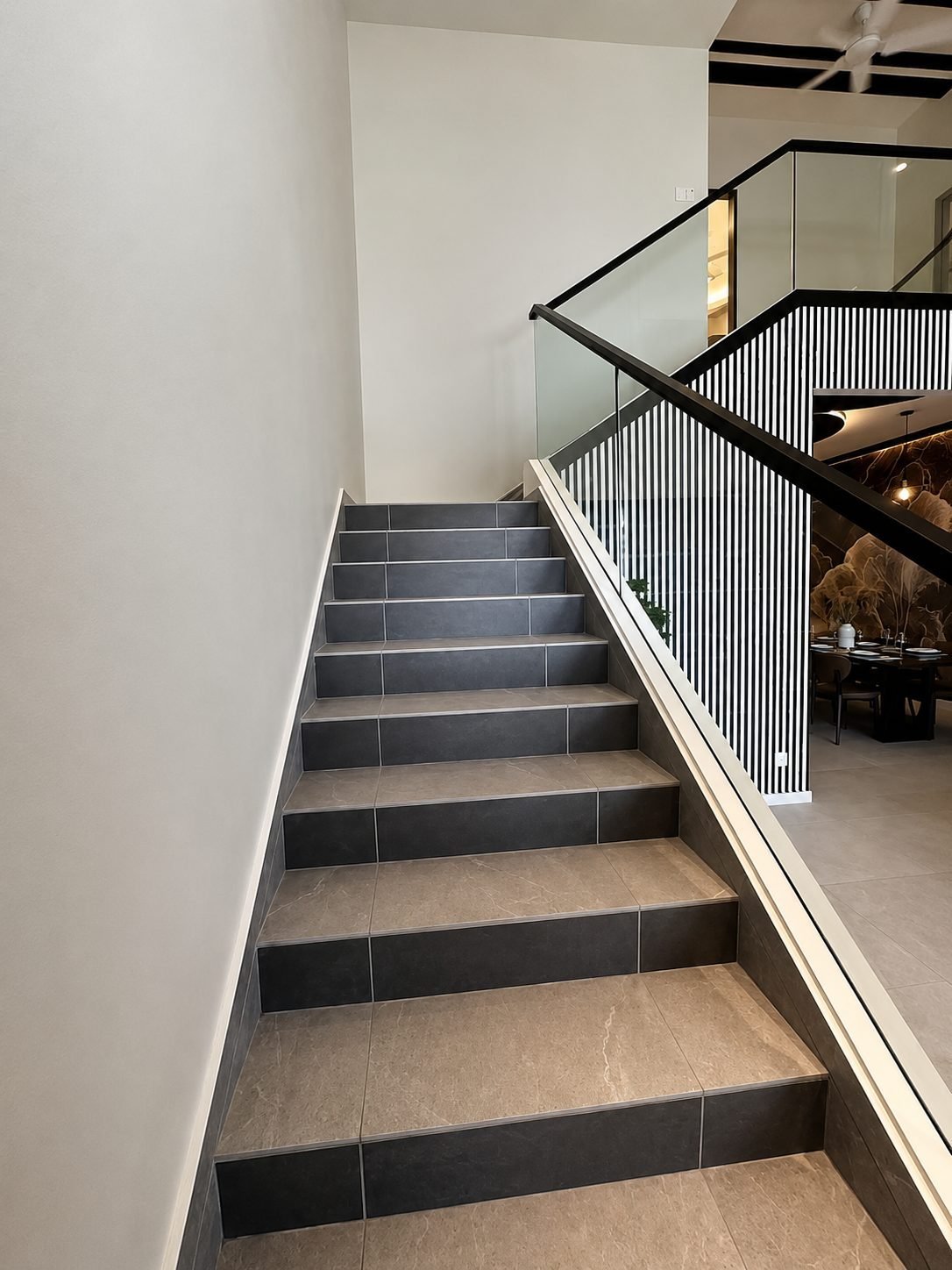 Staircase with a glass balustrade rising to the mezzanine, Pearl Garden 1.5-storey