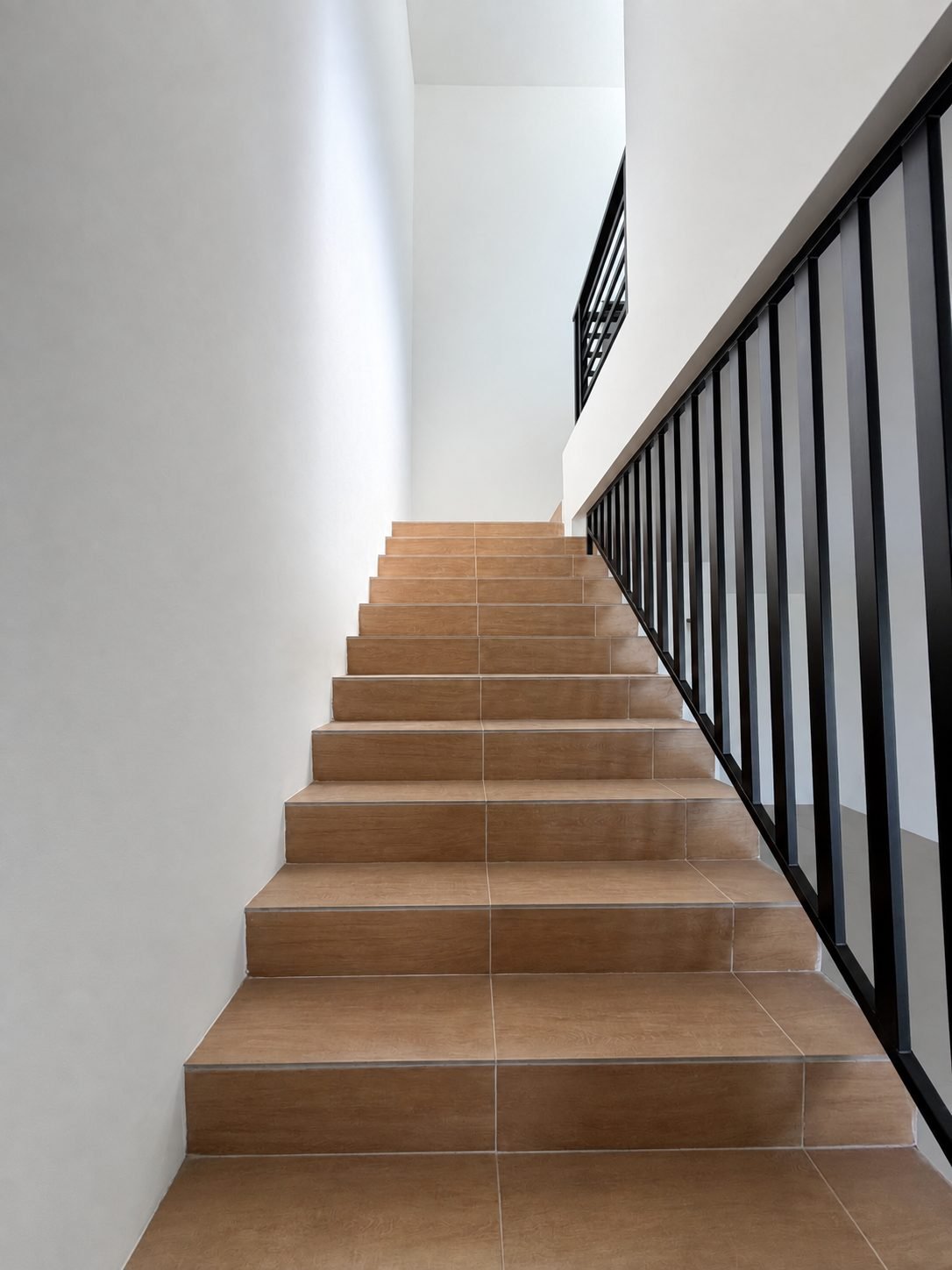 Staircase with timber treads and a black balustrade, double-storey show house