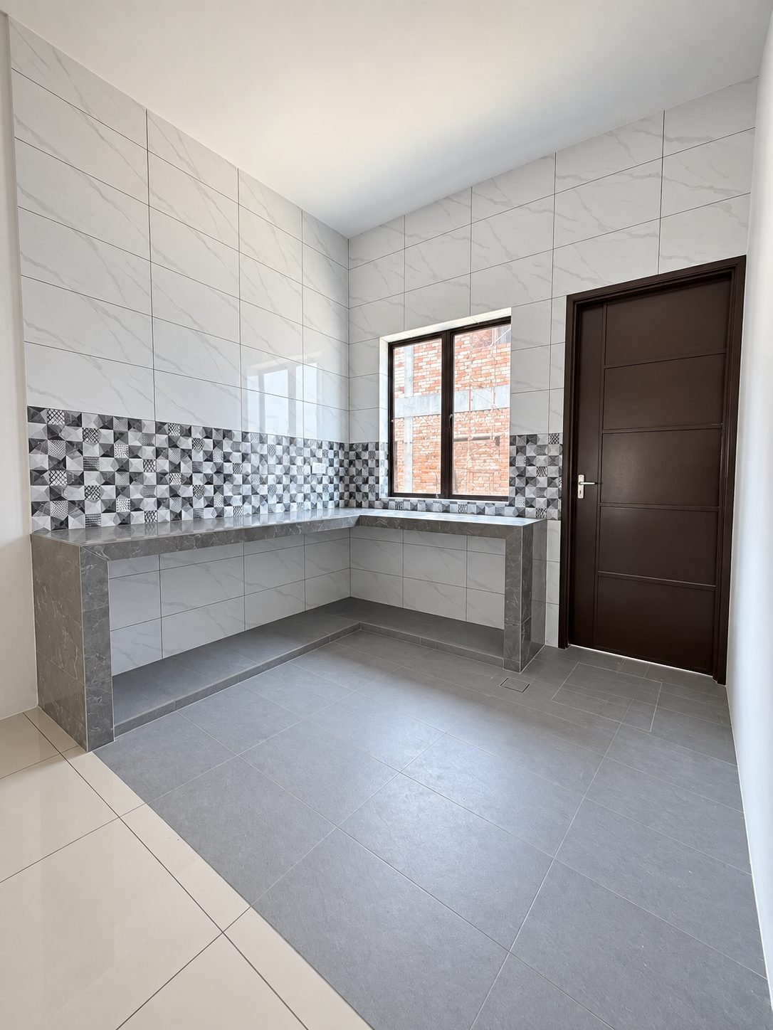 Fitted kitchen counter and tiled splashback, single-storey show house at Taman Raia Saujana III