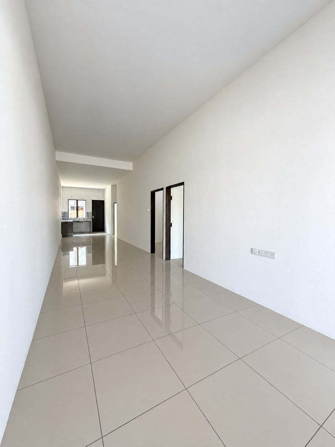 Unfurnished room looking through to the next, single-storey show house