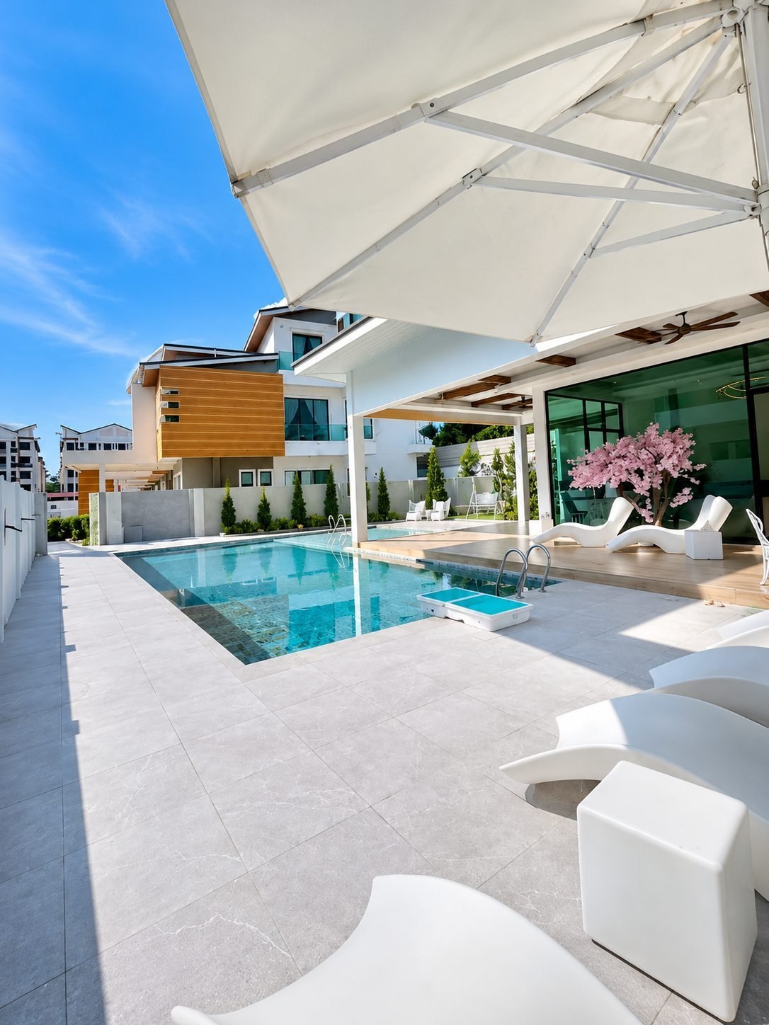 Pool deck with loungers at Thompson Prestige, Ipoh