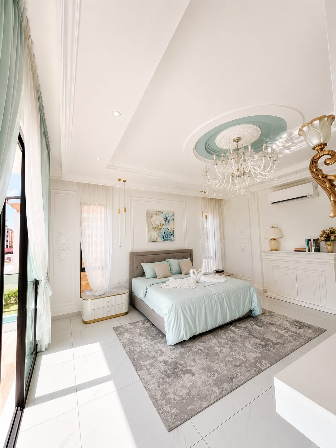 Master bedroom under a high ceiling and chandelier, Thompson Prestige show house